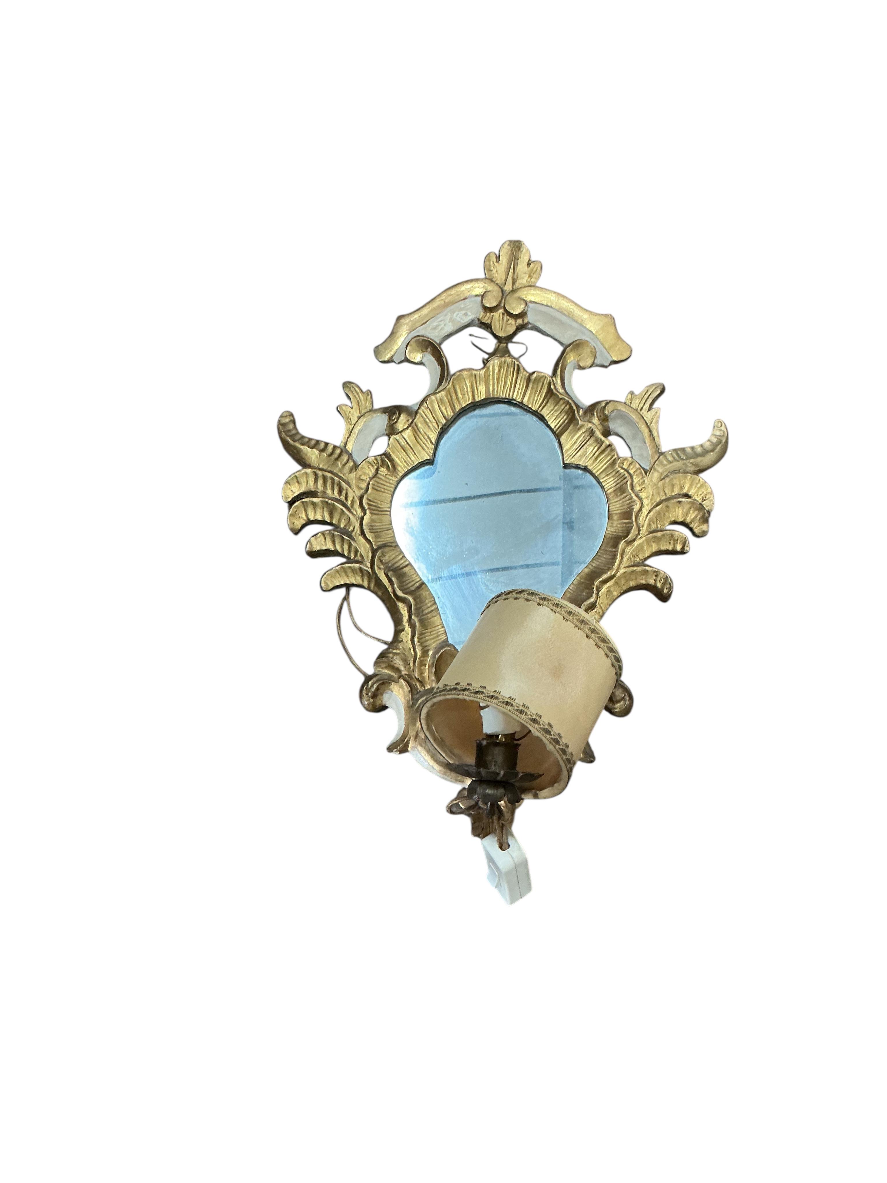 A pair of Italian parcel gilt framed Rococo Revival single light girandole wall mirrors, width 36cm, height 48cm